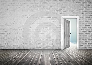 Doorway opening to blue sky in grey brick wall room