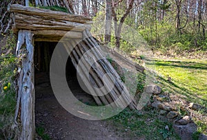 Doorway to a rustic hut with sod exterior and open doorway magical