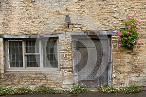 Doorway and window in idyllic cottage, Castle Combe, UK