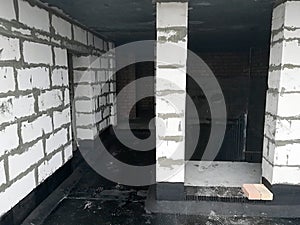Doorways in the attic of a multi-story building of gas silicate blocks at a construction site. Exit to the roof