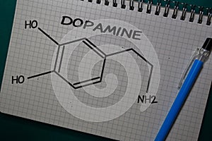 Dopamine write on a book. Structural chemical formula. Education concept photo