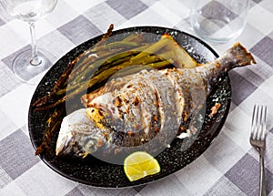 Dorada fish served with potatoes and asparagus