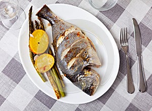 Dorada fish served with potatoes and asparagus