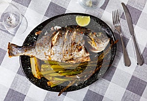 Dorada fish served with potatoes and asparagus