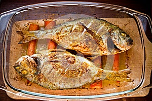 Dorade with curry on carrots in oriental style