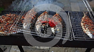 Dorado fish grilled over charcoal.cooking seafish on barbecue grill plate. Baking roasting marinated delicious seafood.