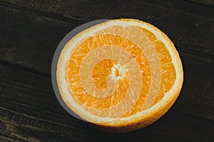 Dorange slices on an orange wooden background. Top view