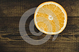 Dorange slices on an orange wooden background. Top view