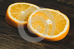 Dorange slices on an orange wooden background. Top view