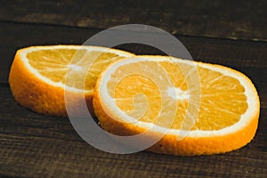 Dorange slices on an orange wooden background. Top view