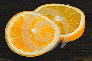 Dorange slices on an orange wooden background. Top view