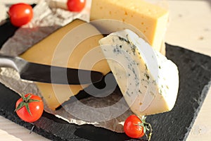 Dorblu cheese with tomatoes on a stone board