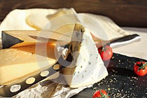 Dorblu cheese with tomatoes on a stone board