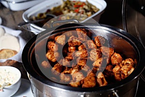 Dore chicken cut into cubes and served in pan