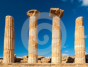 Doric columns of the Heracles temple in Agrigento with blue sky in background Sicily, Italy