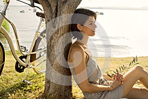 Dormant woman in love waiting under an olive's tree