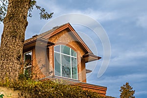 Dormer in the blue sky background. Beautiful Home Exterior. Real Estate Exterior Front House in residential neighborhood