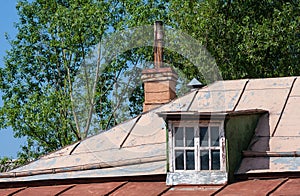 Dormer and chimney on the roof of an old village house.
