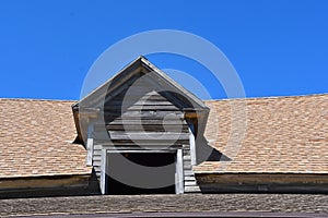 Dormer with old weathered wood and modern shingles