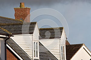 Dormer roof windows. Loft structures on modern town house buildings