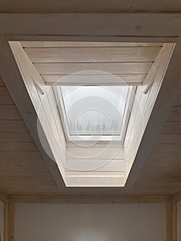 Dormer window framed with wooden panels. Roof windows.