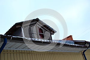 Dormer window on the roof of a residential building.