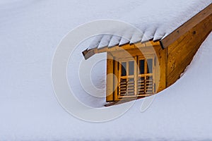 Dormer window on a snow covered roof