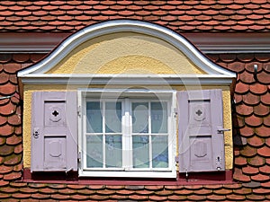 Dormer windows with pink shutters