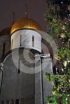 Dormition church and Christmas and New Year 2019 tree on Sobornaya Square of Moscow Kremlin photo