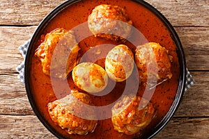 Doro Wat is Ethiopian stew of chicken thighs with eggs in a spicy sauce close-up in a plate. Horizontal top view photo