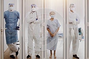 4 of Dortor, Nurse and patient looking out in the quarantine room photo