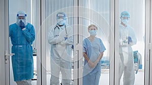 4 of Dortor, Nurse and patient looking out in the quarantine room