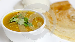 Dosa, idli with sambar and dal in white background for indian dinner or breakfast