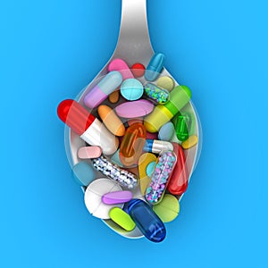 Dose of colorful pills in spoon