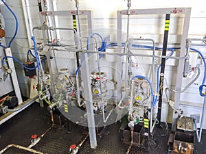 Dosing pumps in reagent block. Chemicals are fed into the system to better delaminate the oil and water emulsion.