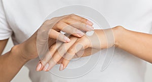 Dot of cream. Woman applying moisturizing hand lotion