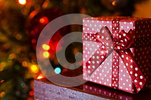 Dotted Christmas gift box on blurred lights background