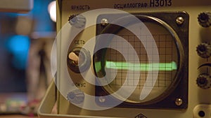 Dotted line on round screen of oscillograph in laboratory