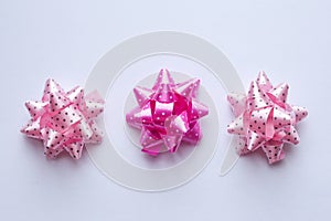 dotty pink bows on a white background