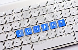 DOUANE writing on white keyboard