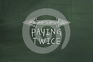 Double arrowed line showing paying twice tax concept on green chalkboard.