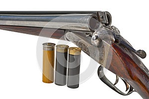 Double-barreled old shotgun and cartridges closeup