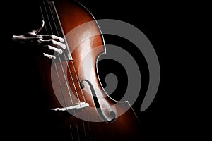 Double bass. Hand playing contrabass player photo
