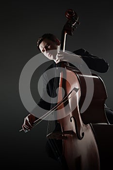 Double bass player contrabass playing with bow