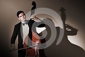 Double bass player playing contrabass photo