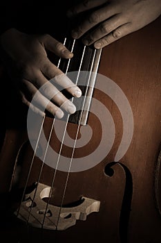 Double bass strings with hands