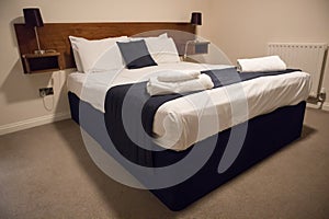 Double bed with bedding in clean simple basic hotel room