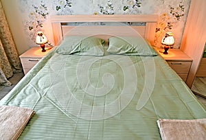 Double bed with green linen