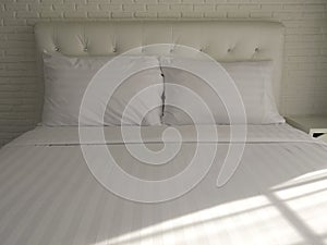 Double bedroom with white pillows and blanket