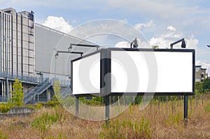 A double blank billboard with lights in a field